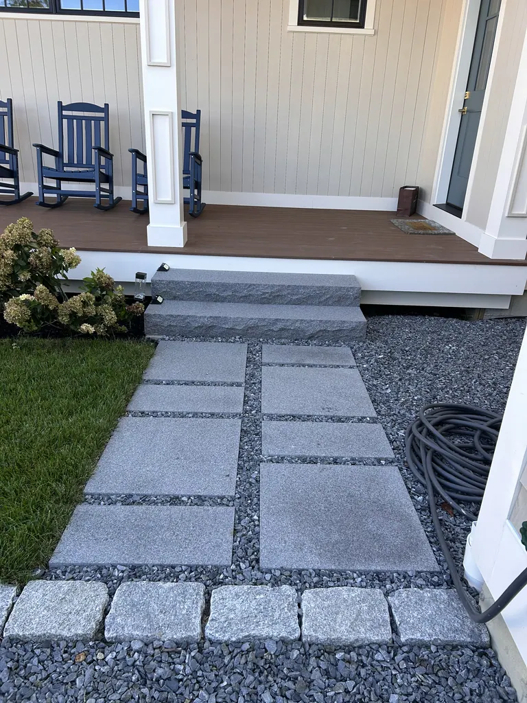 Stone entrance walkway leading to granite porch steps