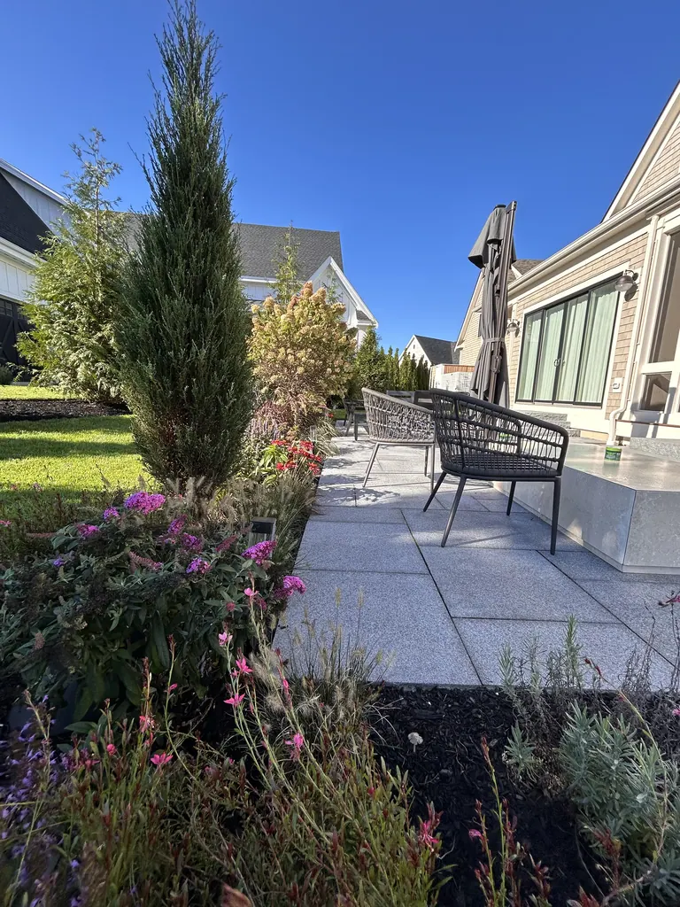 Planted border alongside the furnished stone terrace