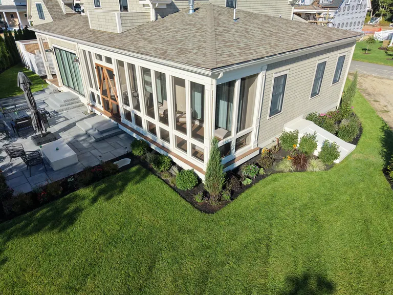 Aerial view of planted garden beds along the gray house and terrace