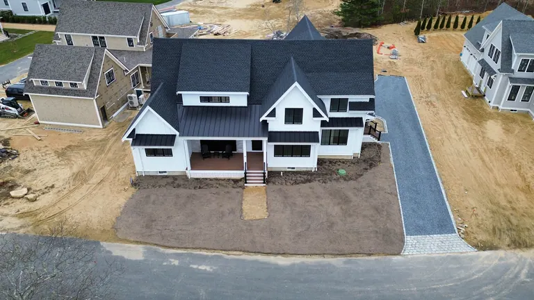 White home with exposed ground before landscape completion