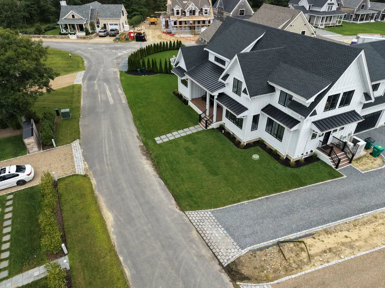 Front lawn and stone paths around the white home