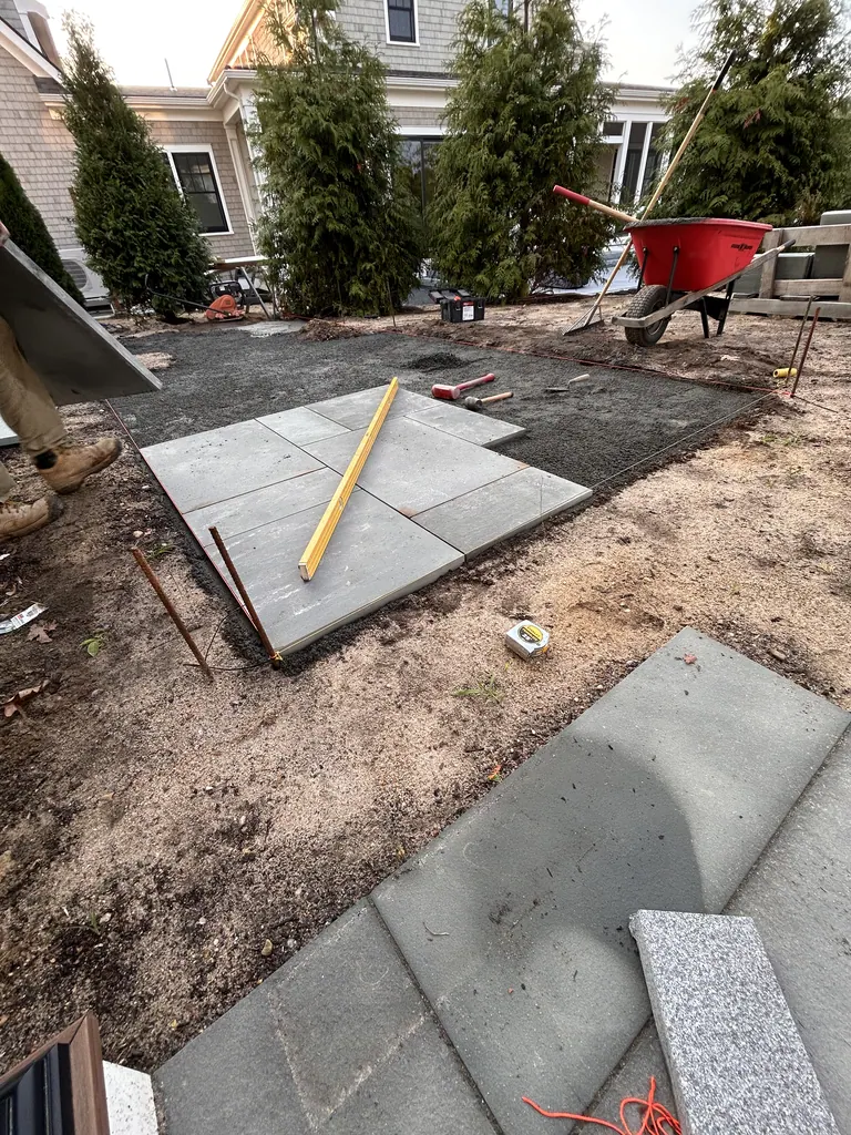 Stone slabs being laid next to the white house