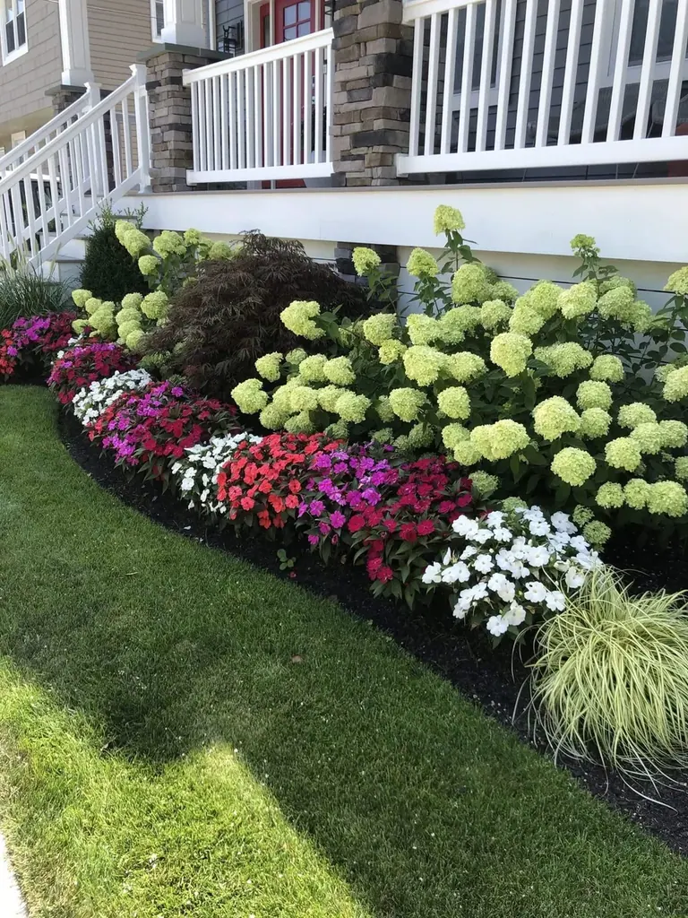 Newly installed garden bed with layered flowering plants beside a Martha's Vineyard home