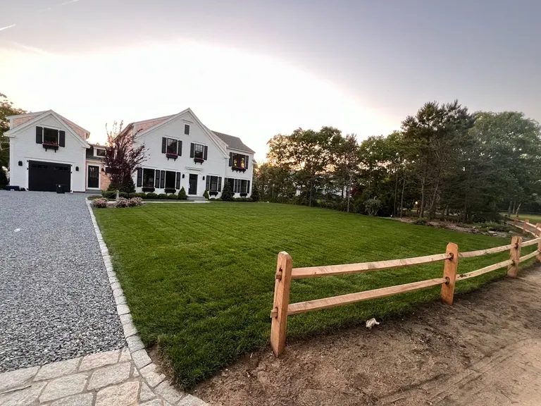 New-construction property with fresh sod lawn and fencing on Martha's Vineyard