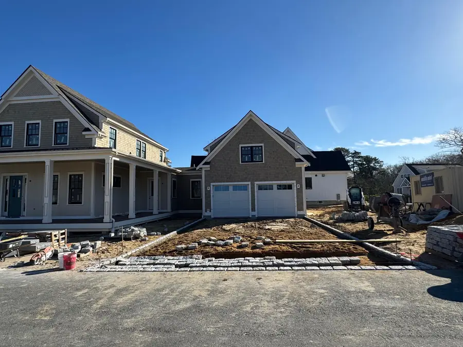 Cobblestone driveway apron being built in front of two new homes under construction