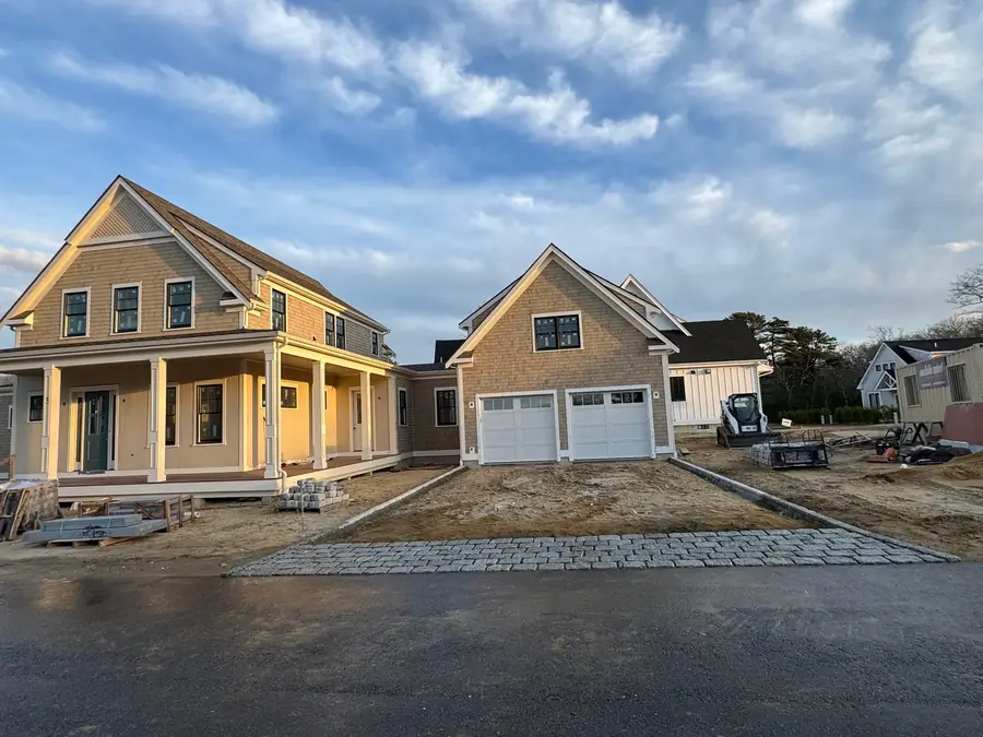 Finished granite cobblestone aprons and graded driveways in front of two new homes