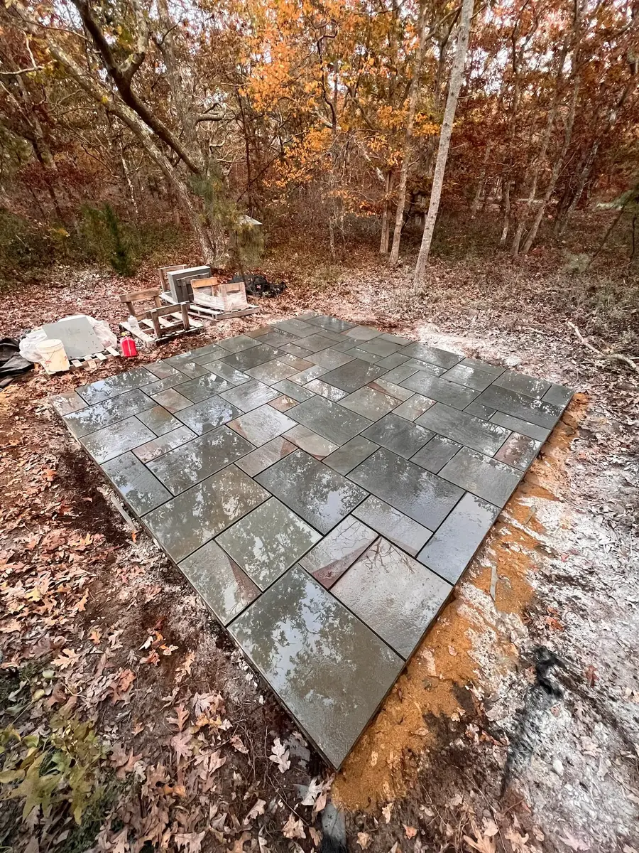 Finished and sealed full-color bluestone patio surrounded by fall woods