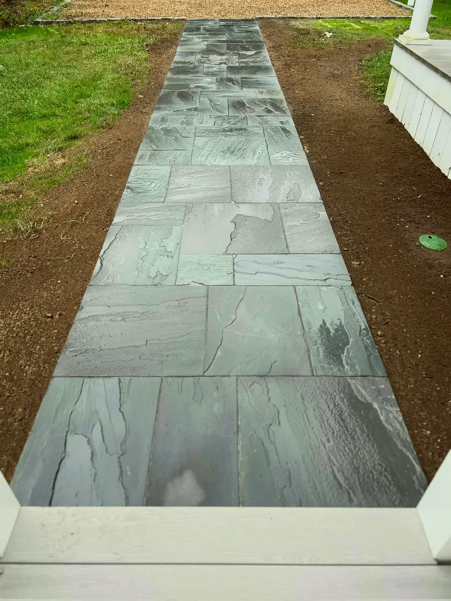 Pattern bluestone walkway leading toward porch steps