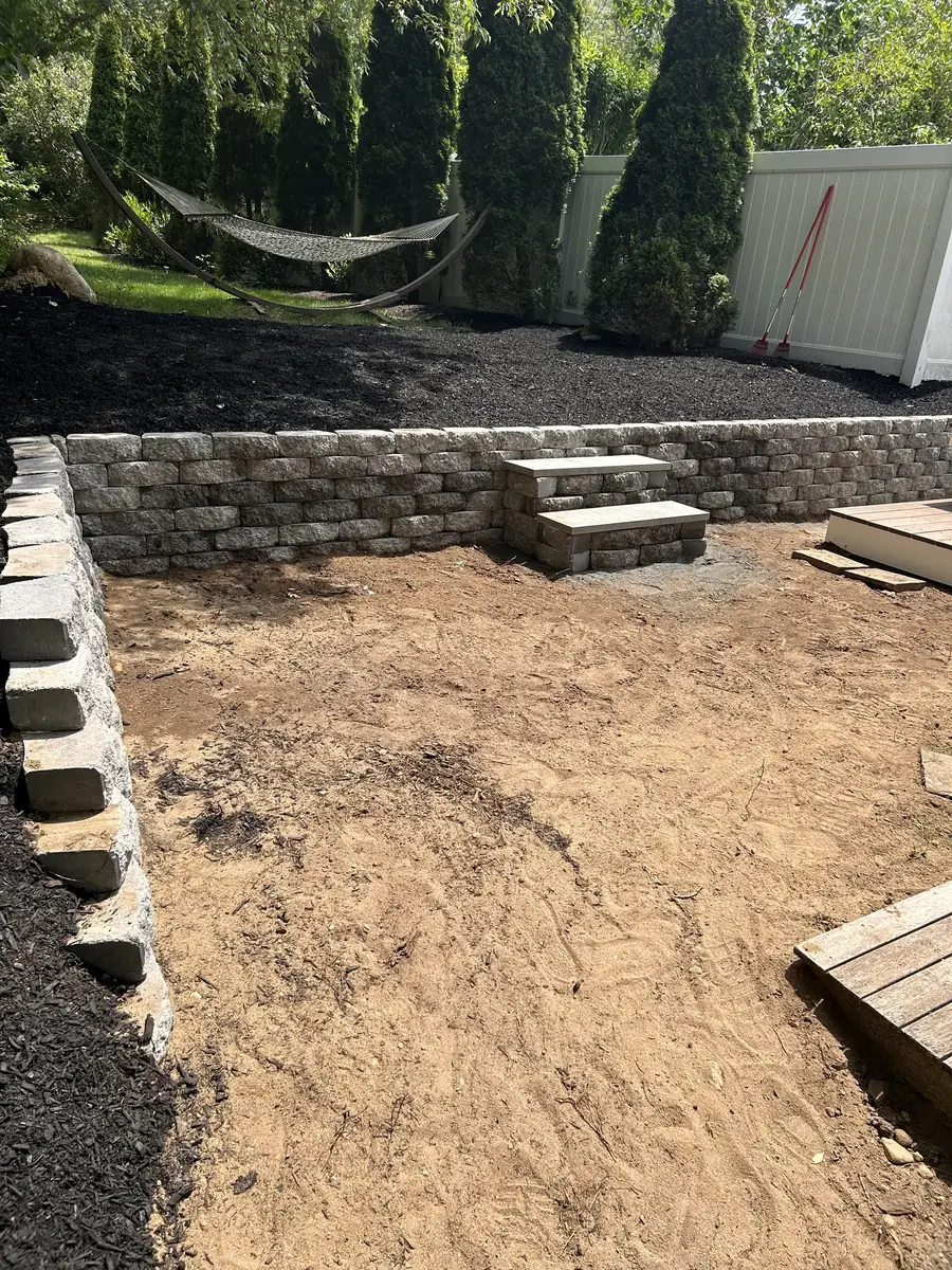 Finished block retaining wall with built-in steps and mulched beds