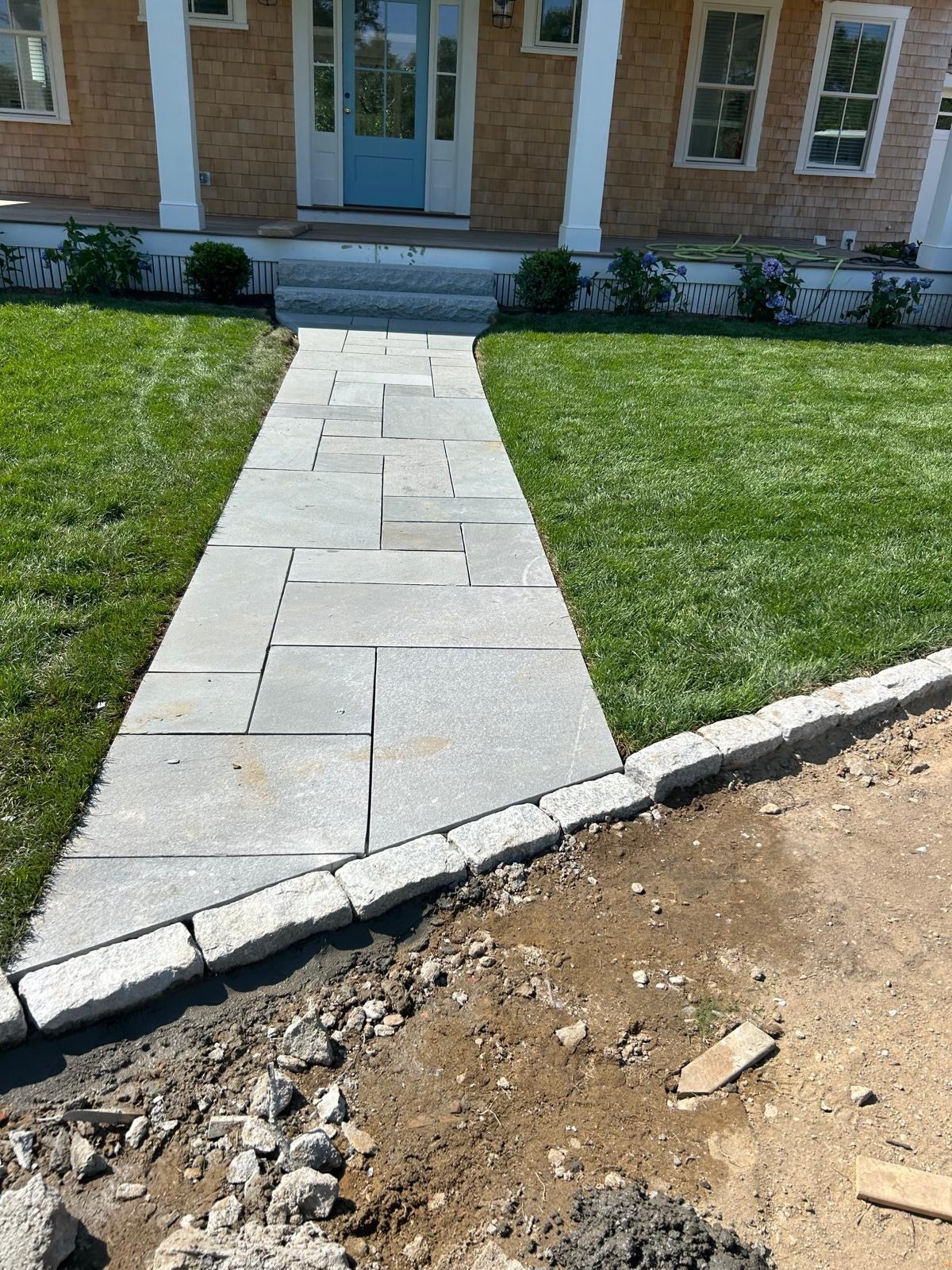 Stone walkway integrated with veneer installation on a Martha’s Vineyard property