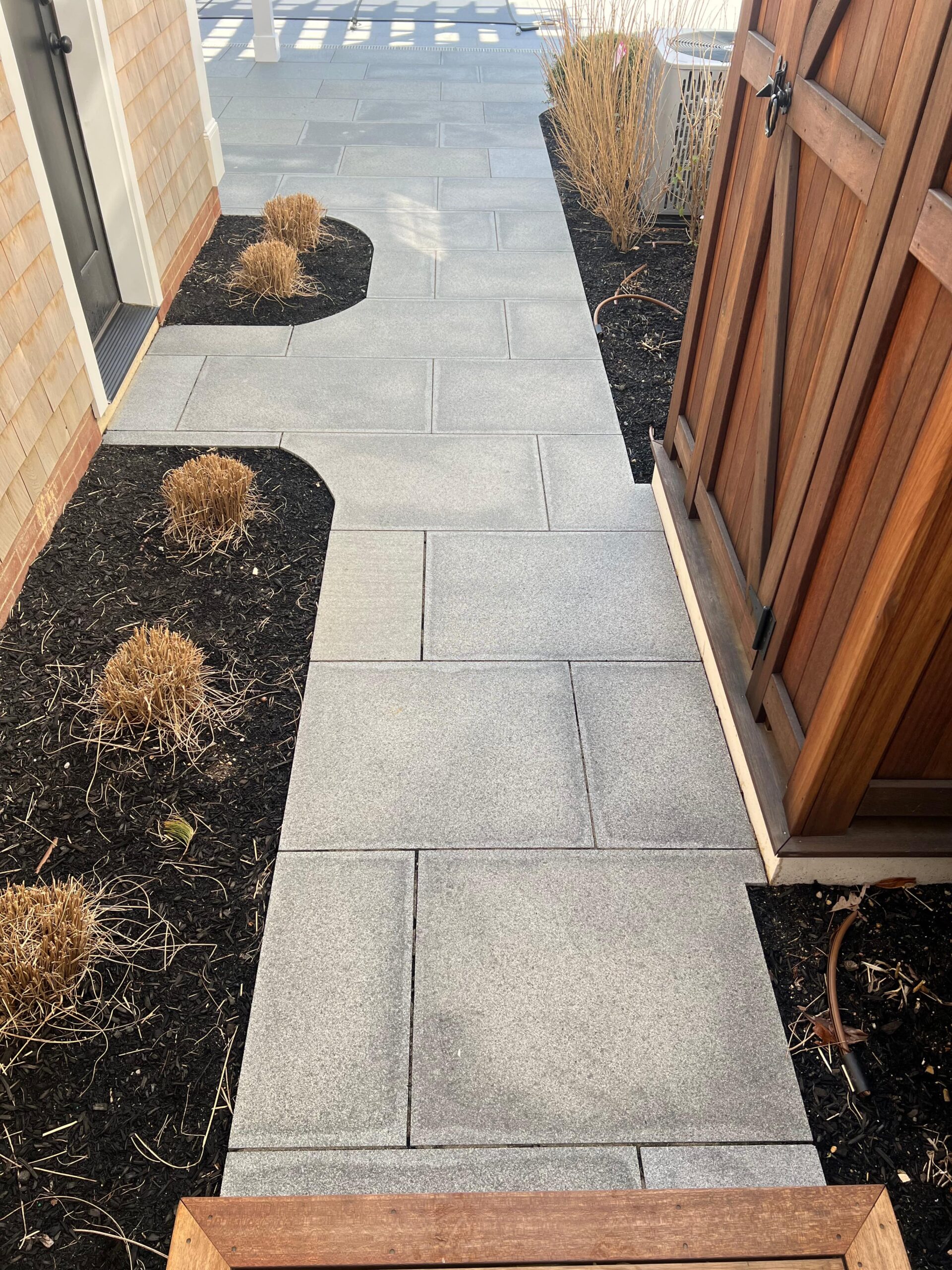 Granite walkway installation services integrated into landscaped grounds on Martha’s Vineyard