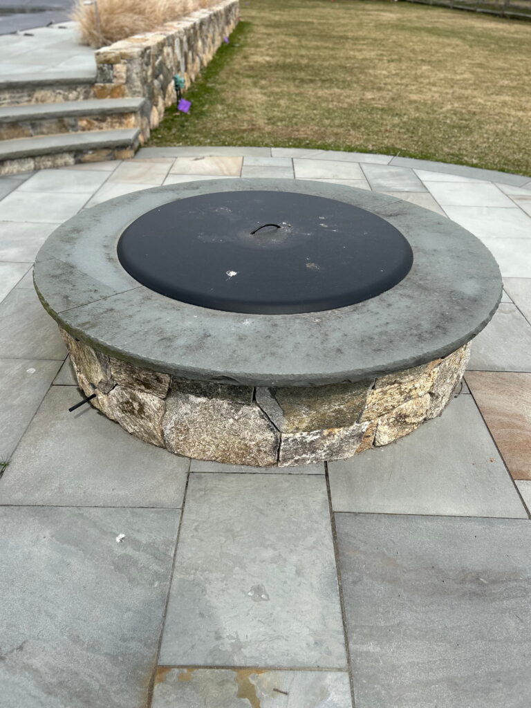 Custom fire pit built in with outdoor BBQ creating a complete outdoor living space on Martha’s Vineyard