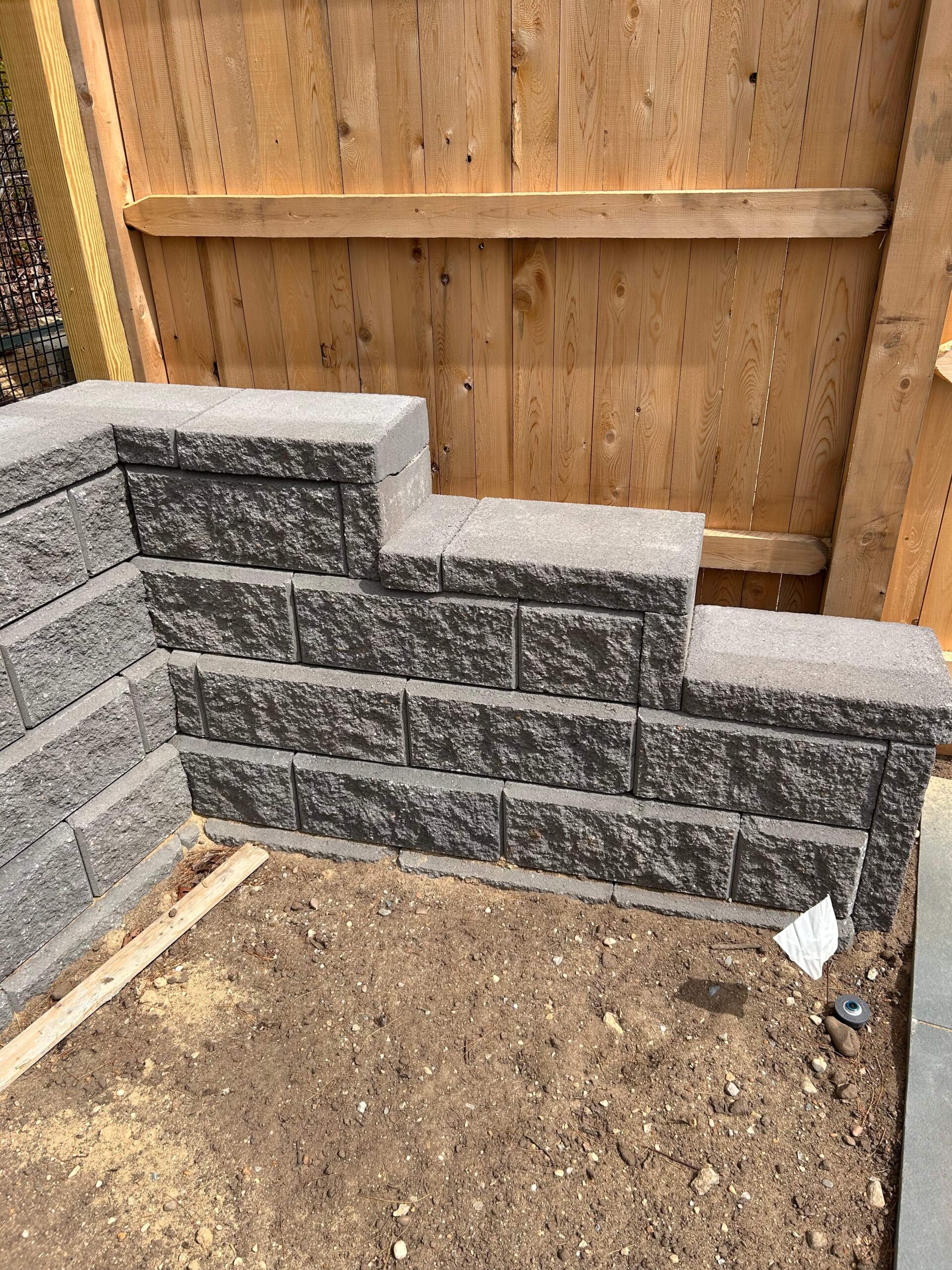 Retaining wall coping installation providing a finished cap on a stone wall on Martha’s Vineyard