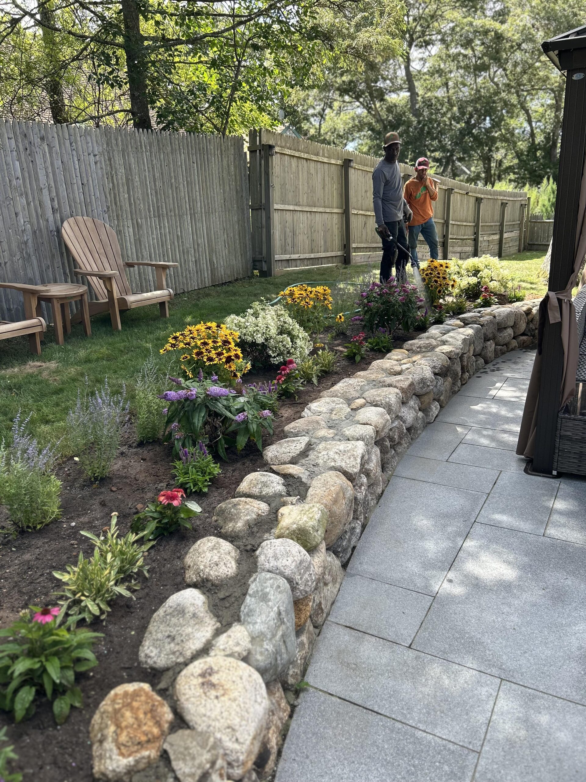 Plant bed maintenance with seasonal flower planting on a Martha’s Vineyard property