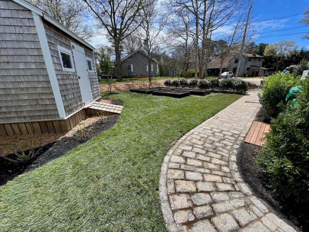 Curved cobblestone walkway installed by a professional landscaping contractor on Martha’s Vineyard.