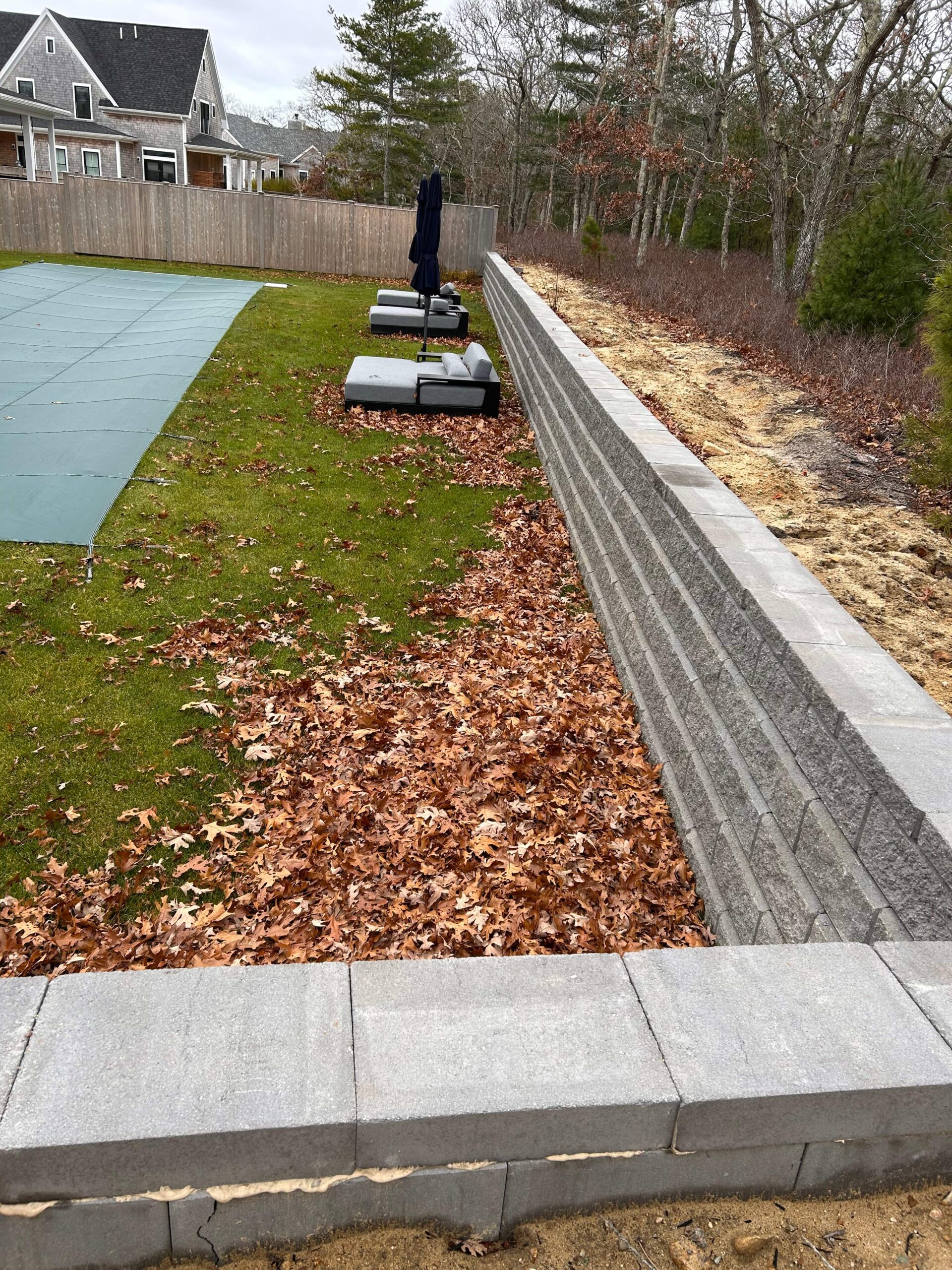 Segmented allan block retaining wall installation providing structural support on Martha’s Vineyard