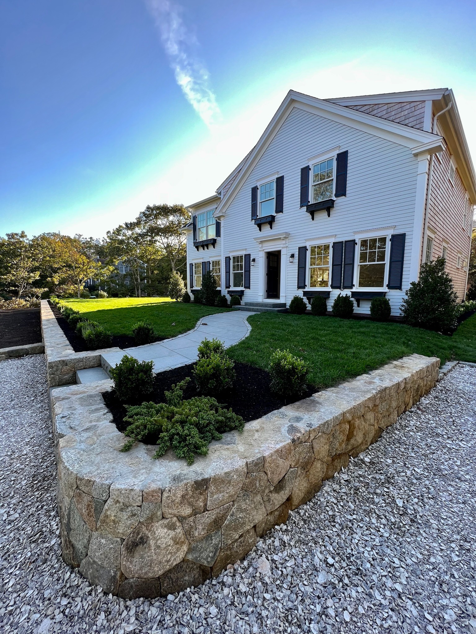 Stone retaining wall installation providing structure and support on a Martha’s Vineyard property