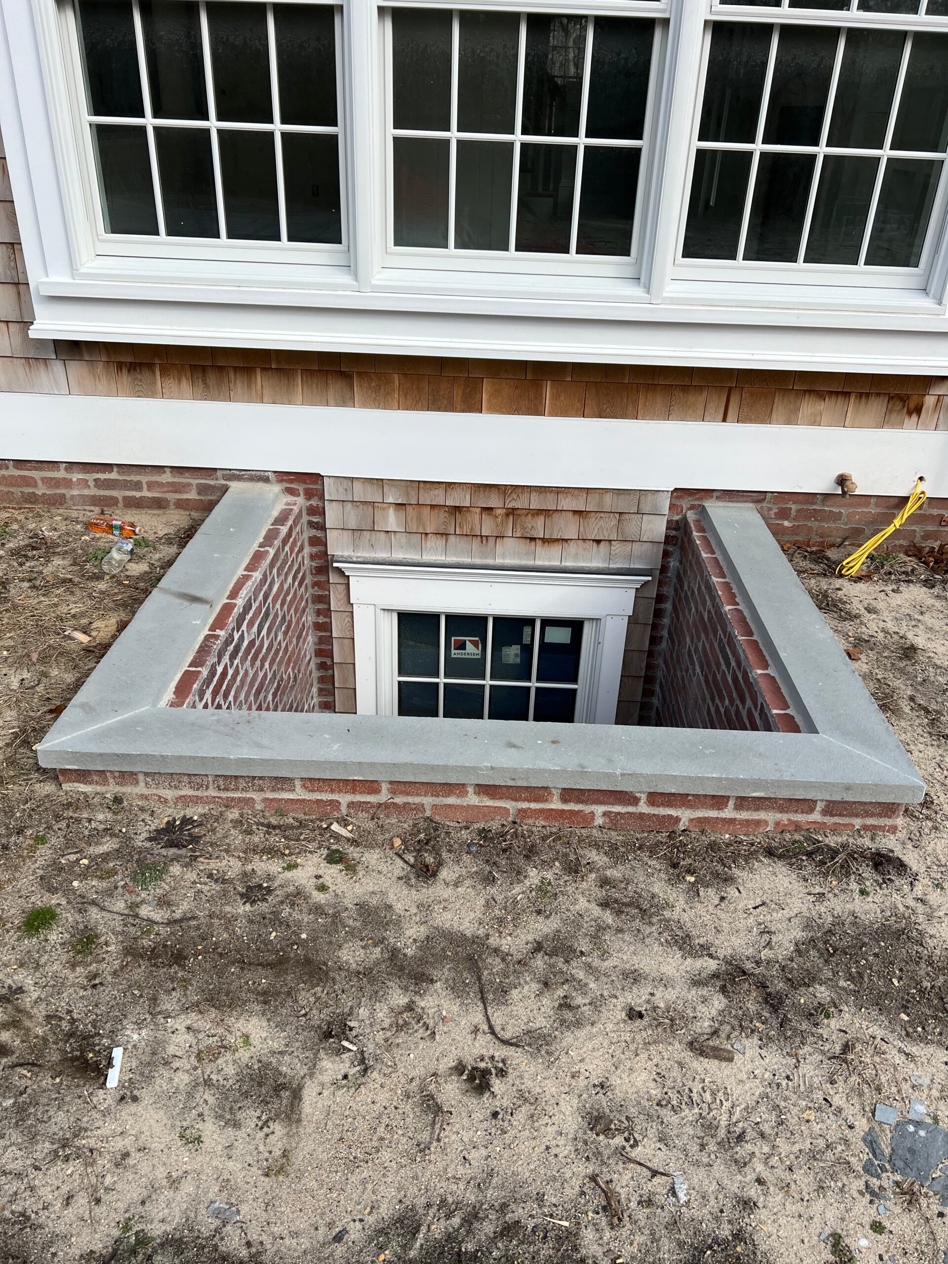 Granite retaining wall coping detail with smooth finished edge on Martha’s Vineyard