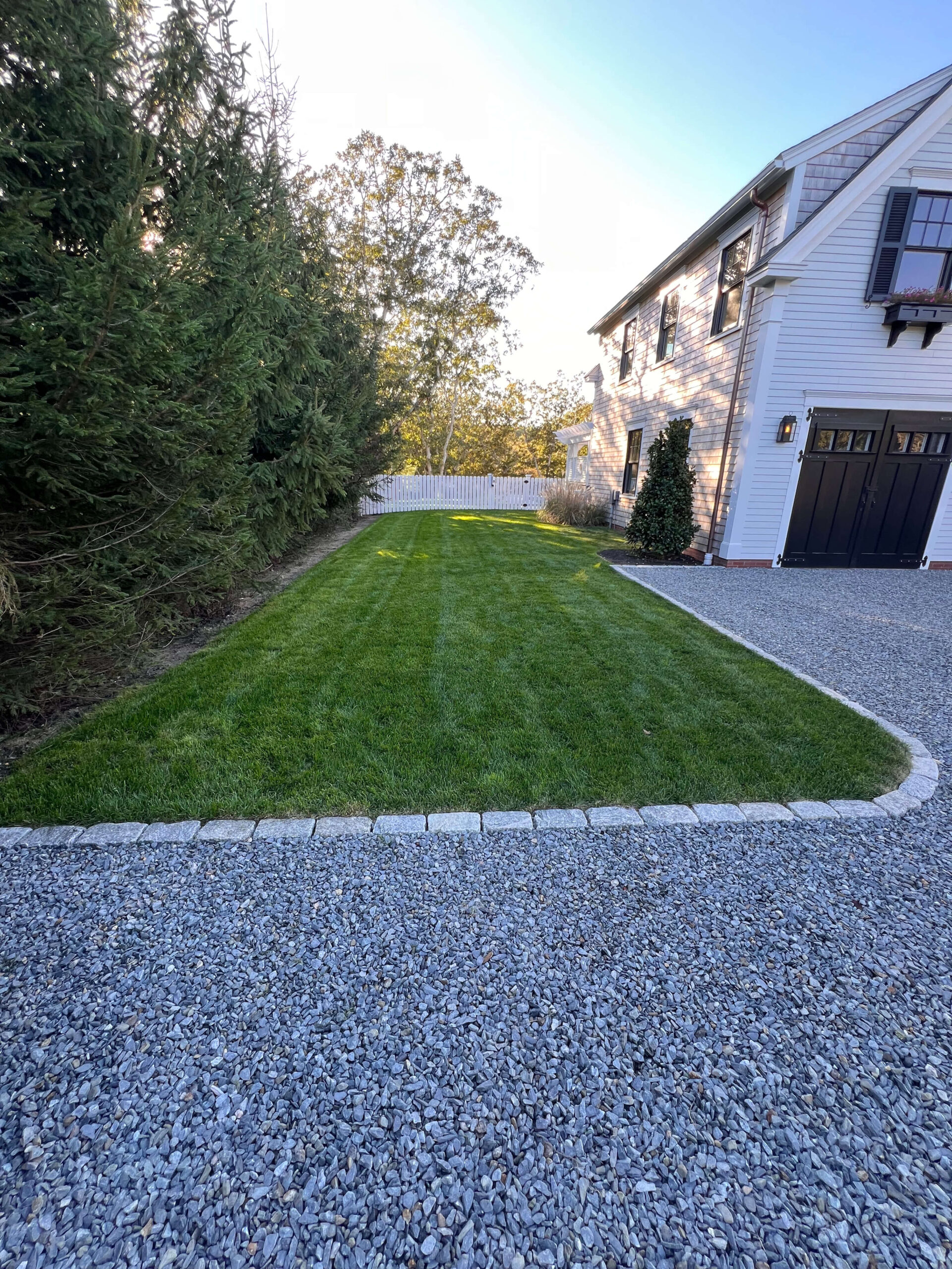 Cobblestone edging installed with blue gravel on Martha’s Vineyard