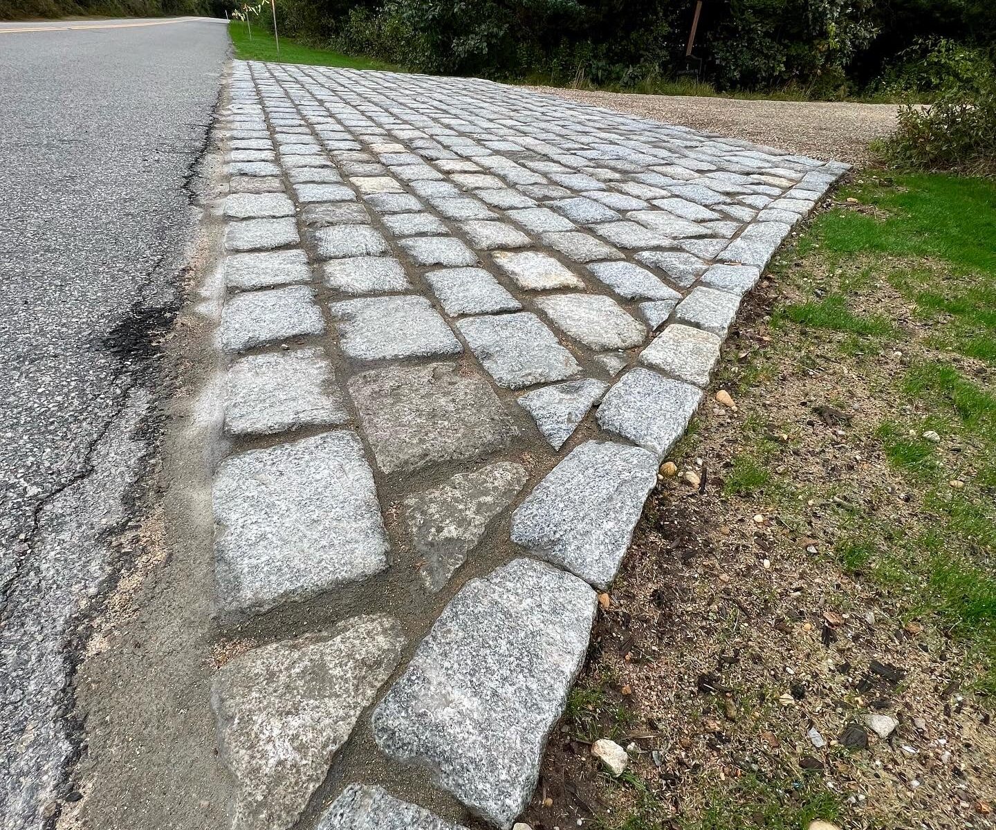Hand-laid cobblestone driveway apron installation at a Martha’s Vineyard home