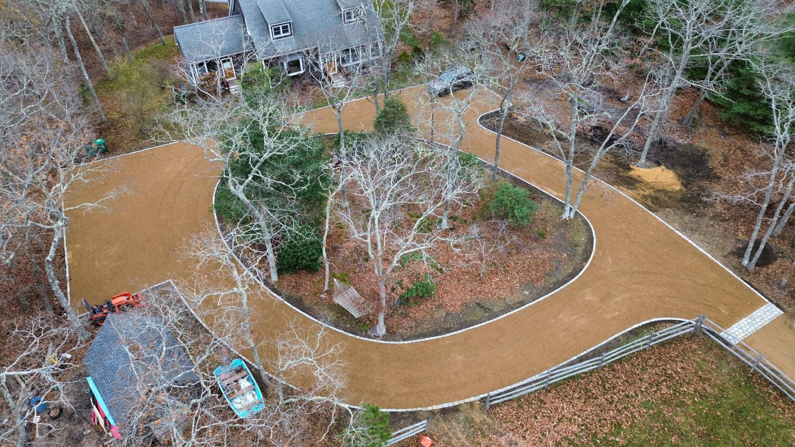 Hand-laid cobblestone driveway installation at a Martha’s Vineyard home by a professional landscaping contractor