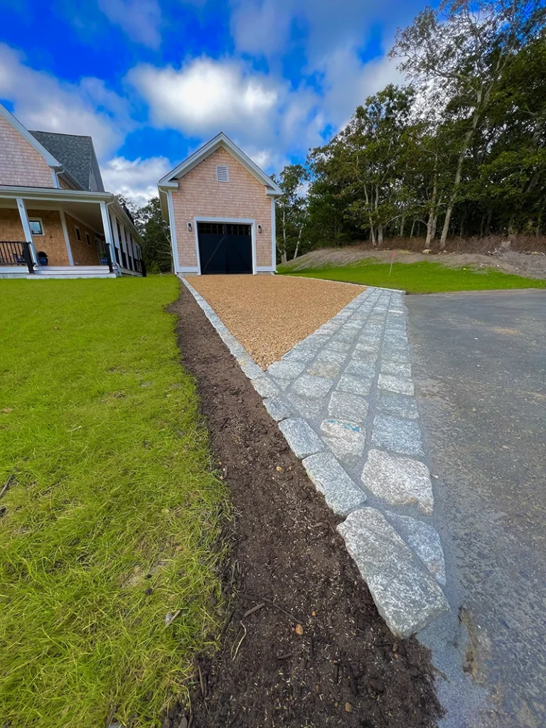 Granite cobblestone apron connecting driveway and public street