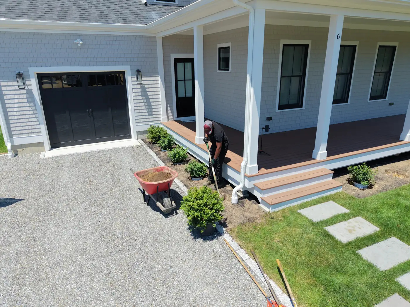 Crew planting a porch bed after the stepping stones and gravel drive