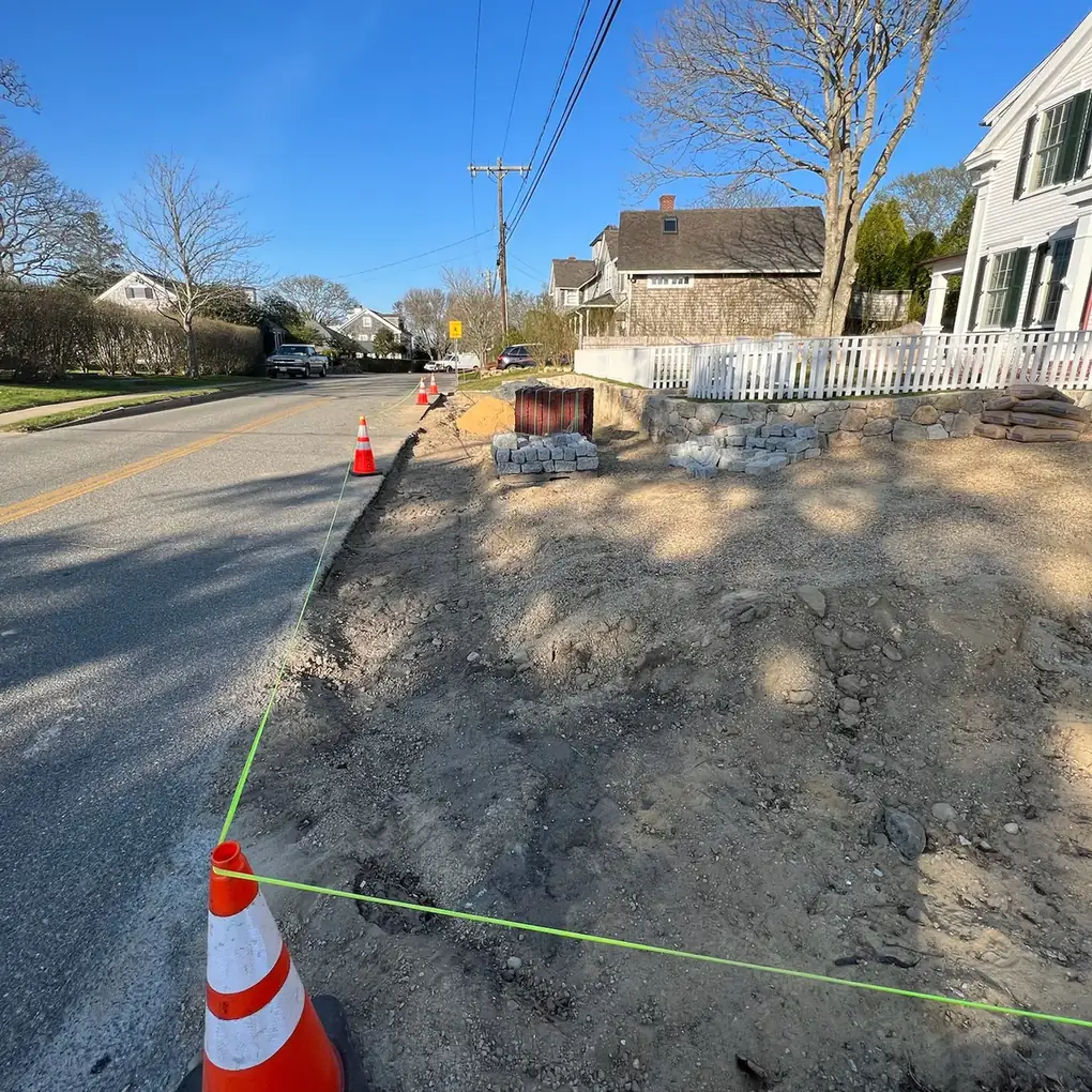 String line and cones marking the curb line for a new apron